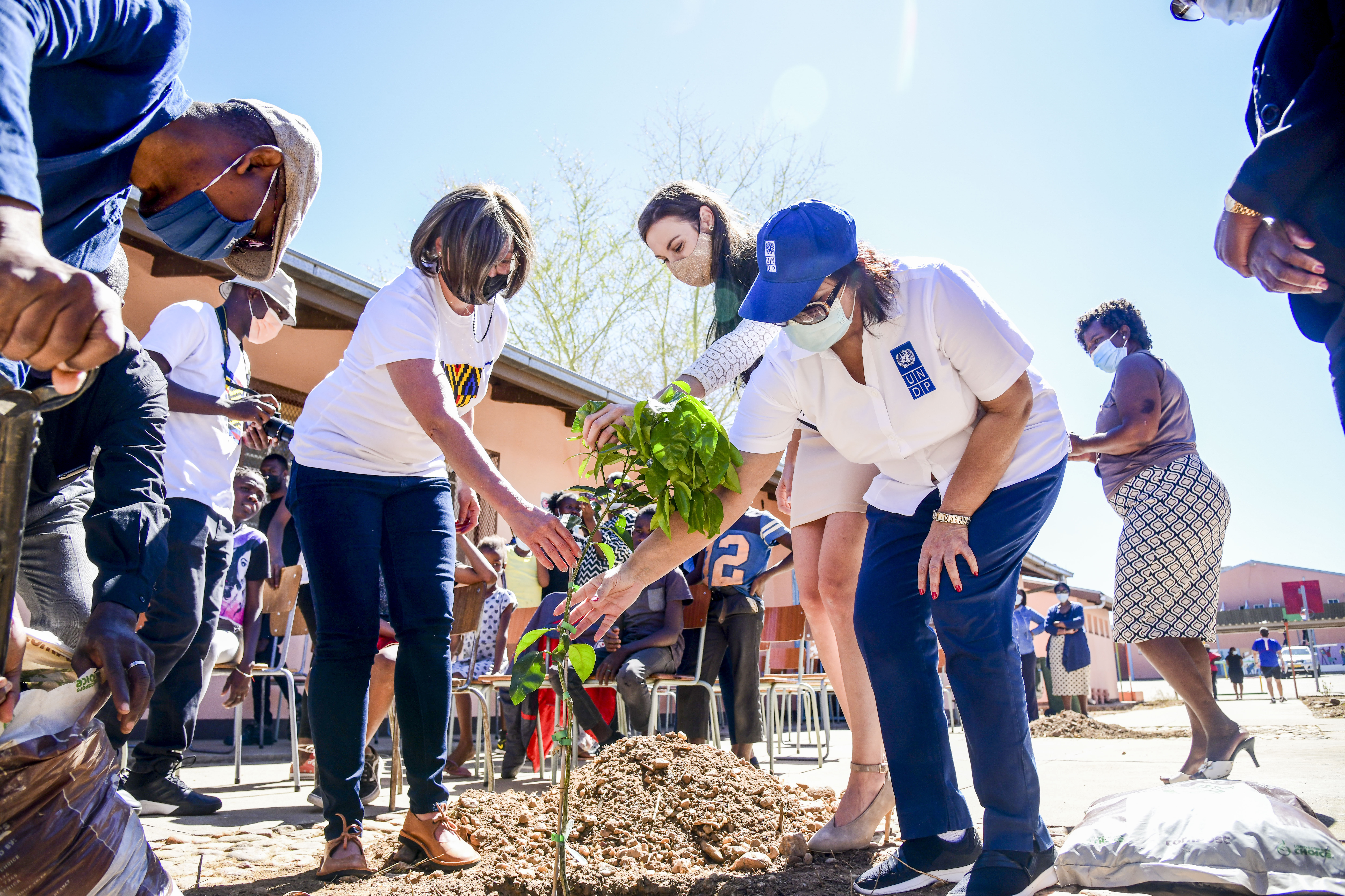 UN Namibia staff plant fruit trees at an aftercare centre