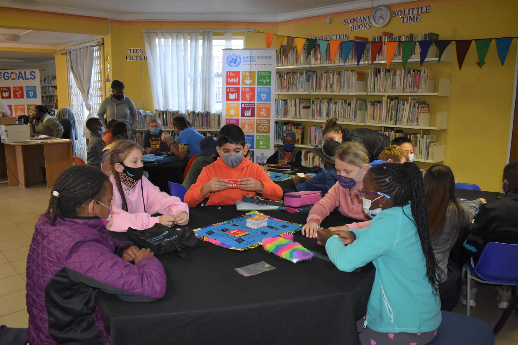 Groups of students playing Swift SDG Edition in the school library