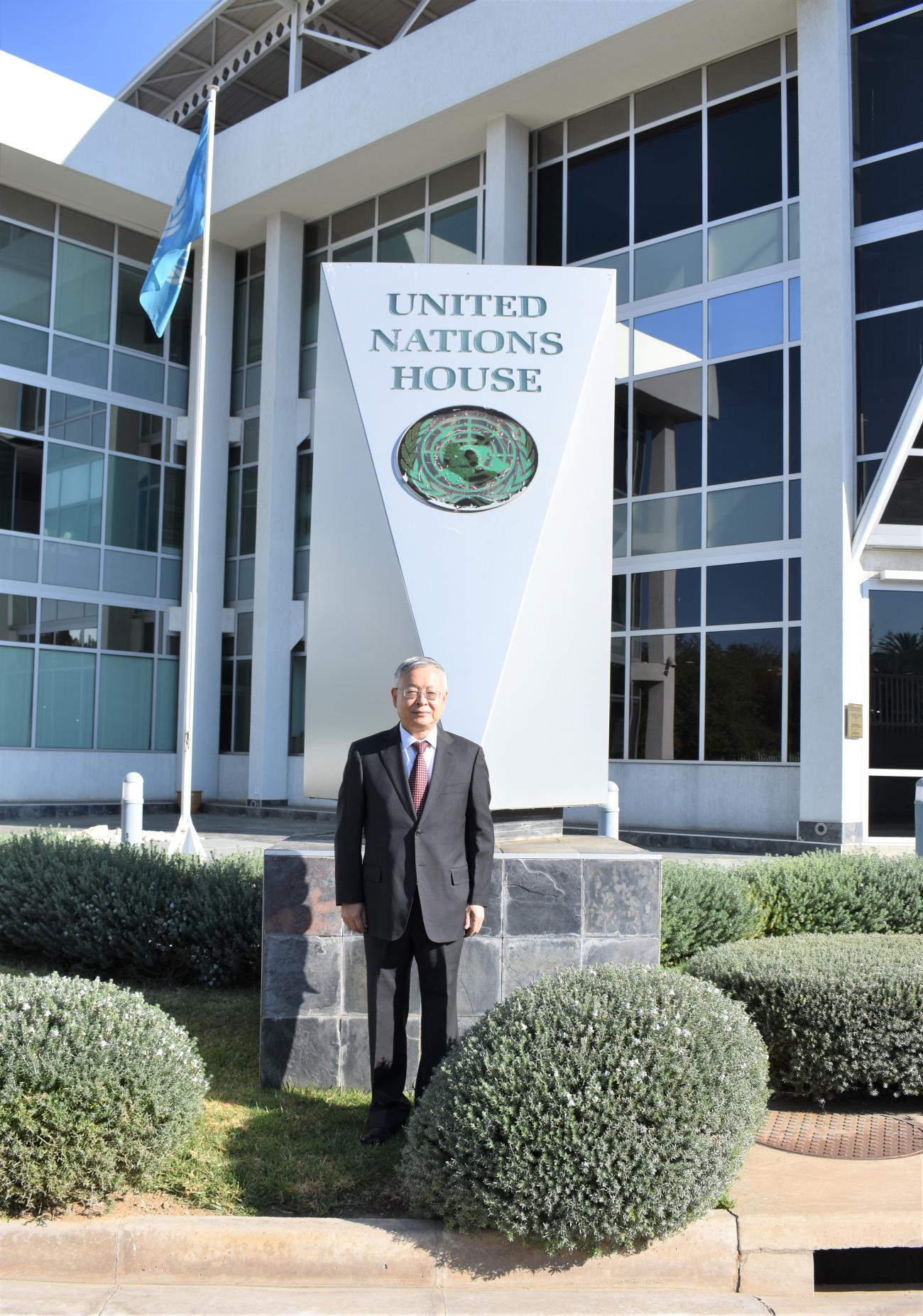 UN Resident Coordinator, Sen Pang pictured infront of the UN House in Namibia