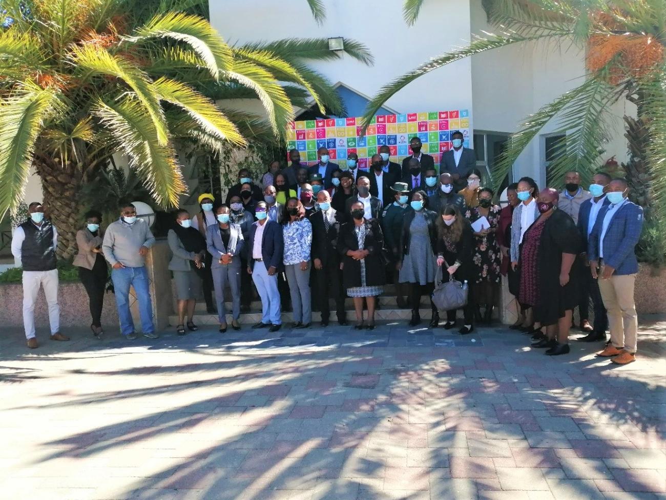 A group of people standing infront of a wall banner