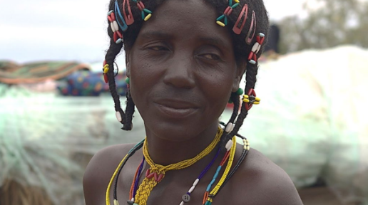 a woman with off camera with colorful hair clips and necklaces